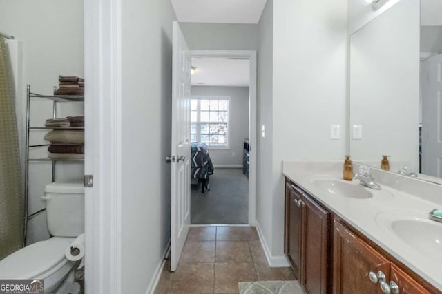 bathroom with tile patterned floors, vanity, and toilet