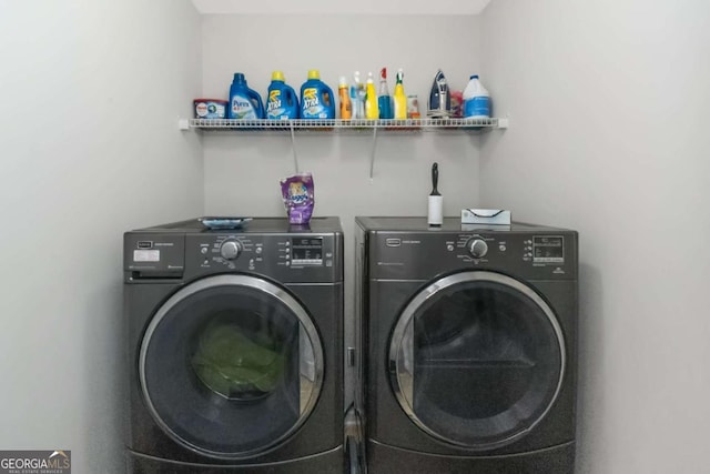 clothes washing area featuring independent washer and dryer