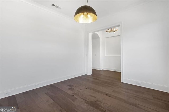 unfurnished room with dark wood-type flooring and ornamental molding