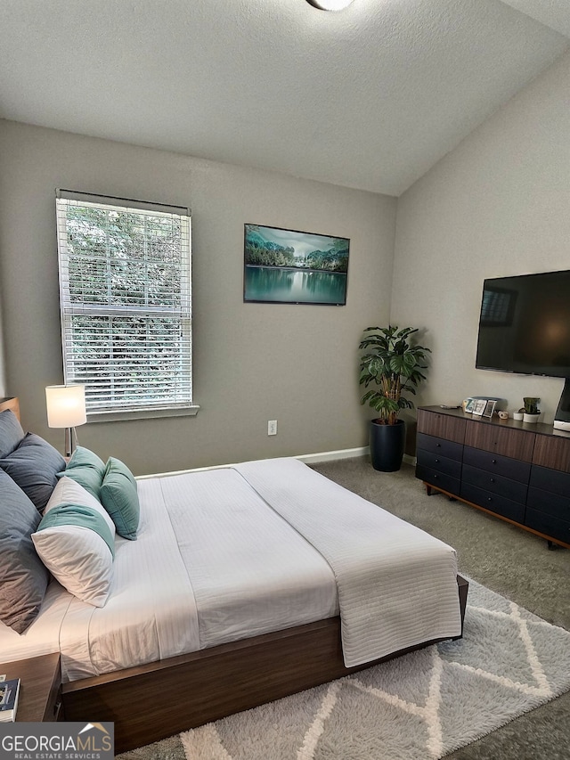 carpeted bedroom featuring a textured ceiling