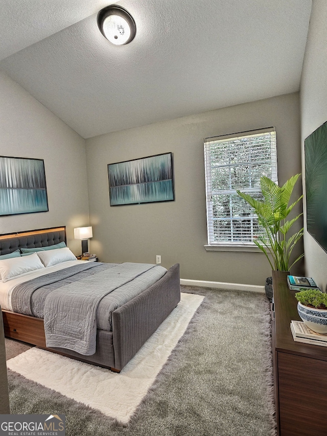 bedroom with vaulted ceiling and carpet floors