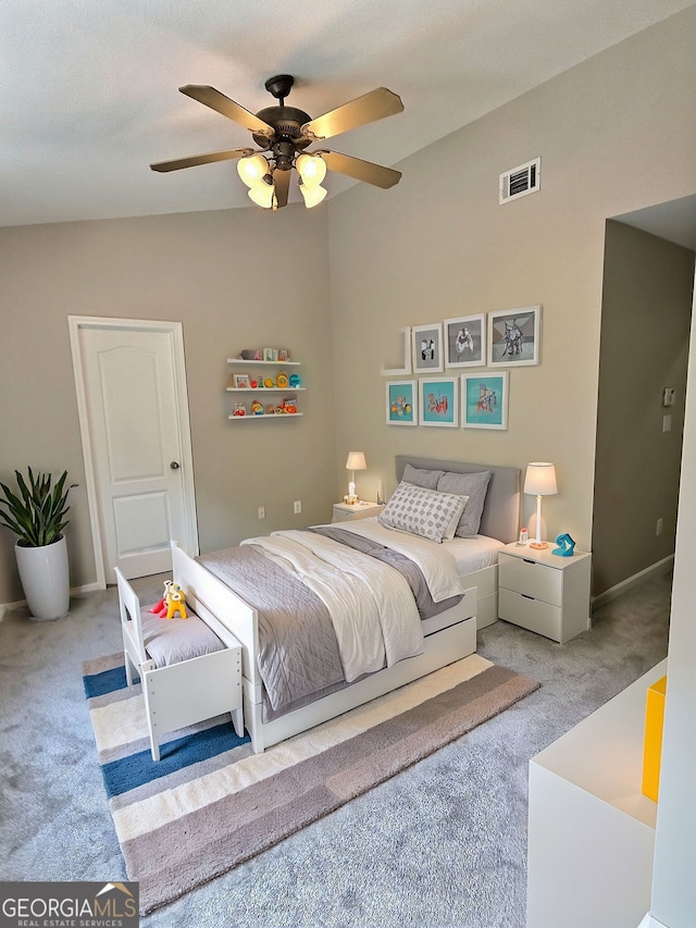 bedroom with ceiling fan, lofted ceiling, and light colored carpet