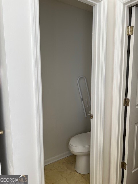 bathroom featuring tile patterned floors and toilet