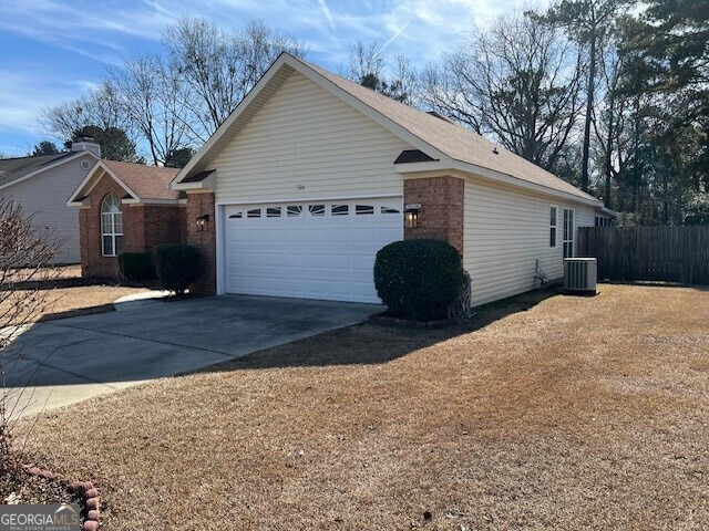 view of home's exterior featuring a garage and central AC