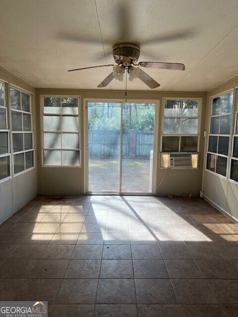 unfurnished sunroom with cooling unit and ceiling fan