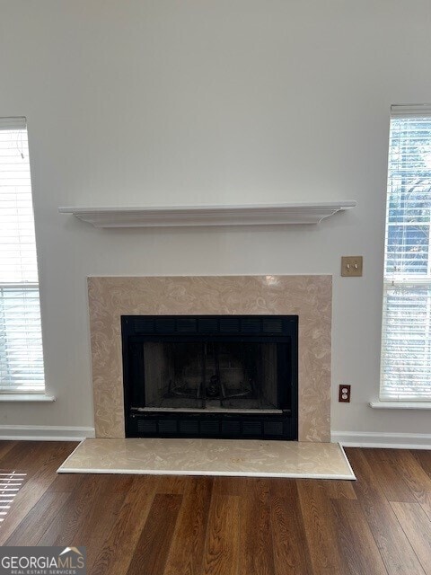 interior details featuring hardwood / wood-style floors and a fireplace