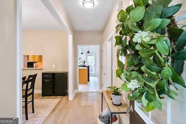 corridor with light hardwood / wood-style flooring