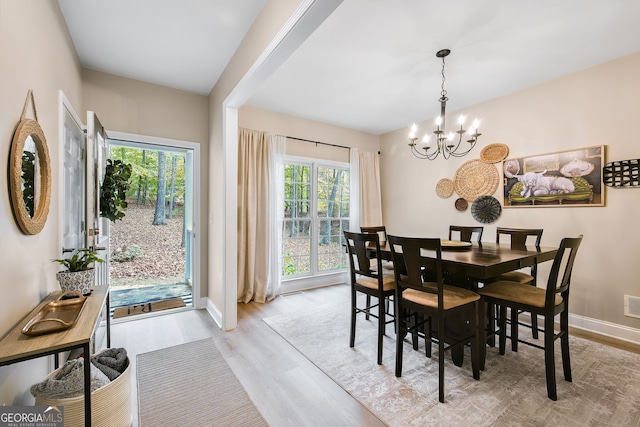 dining area with a chandelier and light wood-type flooring