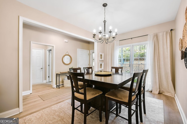 dining room with a notable chandelier and light hardwood / wood-style flooring