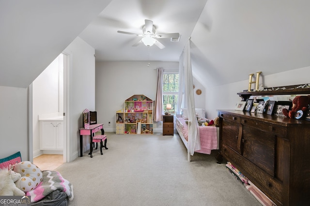 bedroom featuring lofted ceiling, connected bathroom, light colored carpet, and ceiling fan