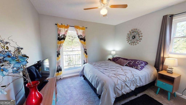 bedroom with ceiling fan, carpet floors, and multiple windows