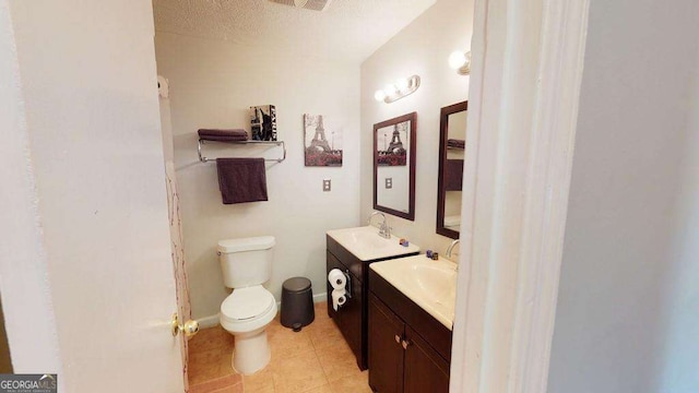 bathroom with vanity, toilet, and a textured ceiling