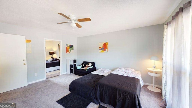 carpeted bedroom with ceiling fan and a textured ceiling