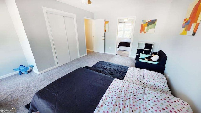 bedroom with carpet floors, ceiling fan, and a closet