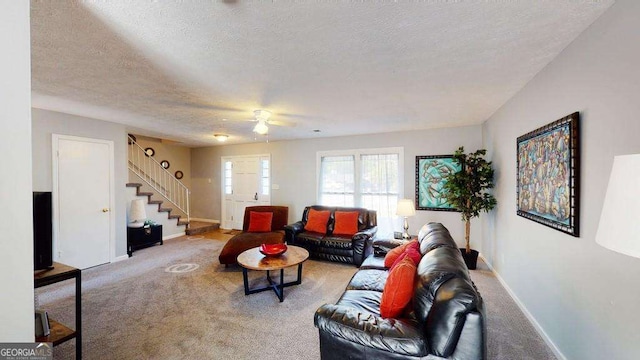 carpeted living room with a textured ceiling