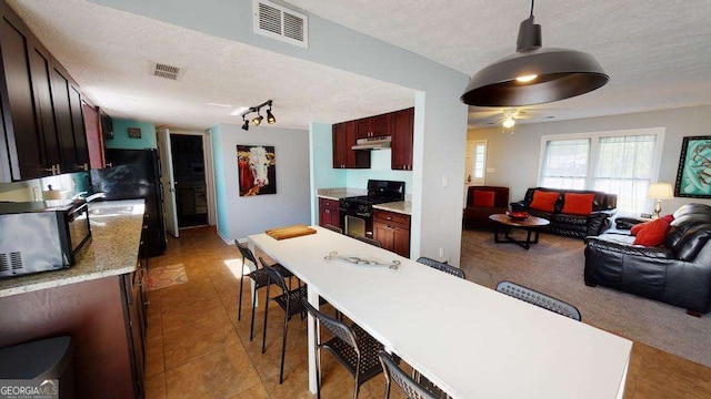 dining space with sink and a textured ceiling