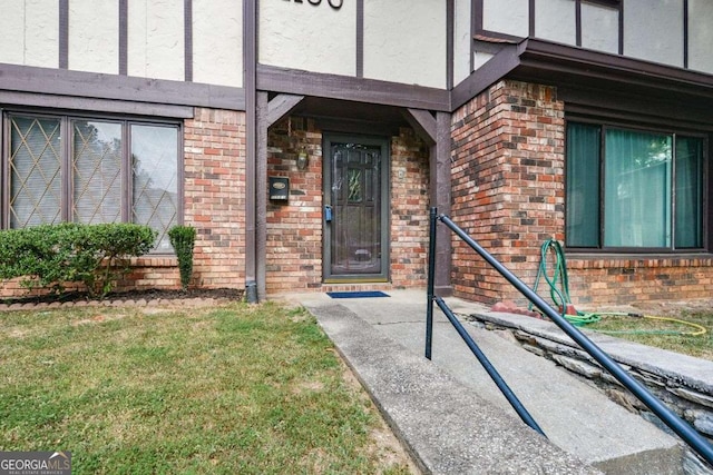 entrance to property with a lawn