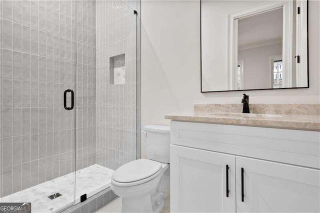 bathroom with vanity, toilet, and walk in shower