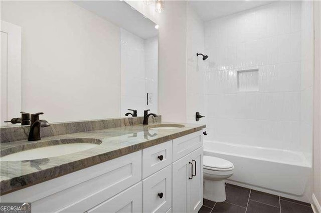 full bathroom with tiled shower / bath, vanity, tile patterned floors, and toilet