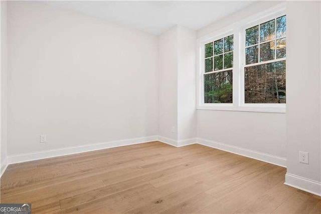 spare room with light hardwood / wood-style flooring