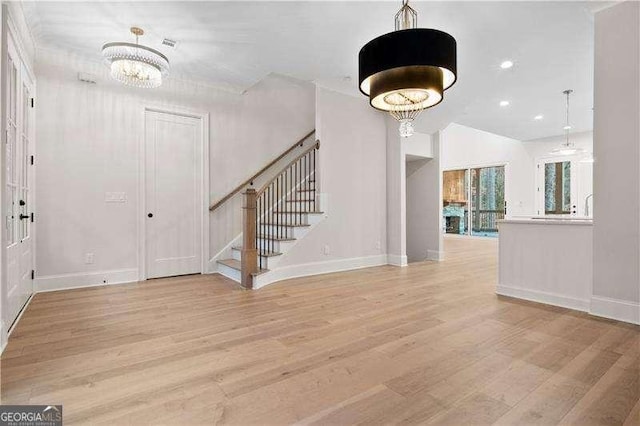 entryway featuring a notable chandelier and light hardwood / wood-style flooring