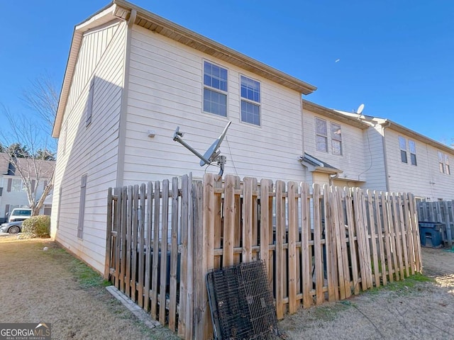 back of house with fence