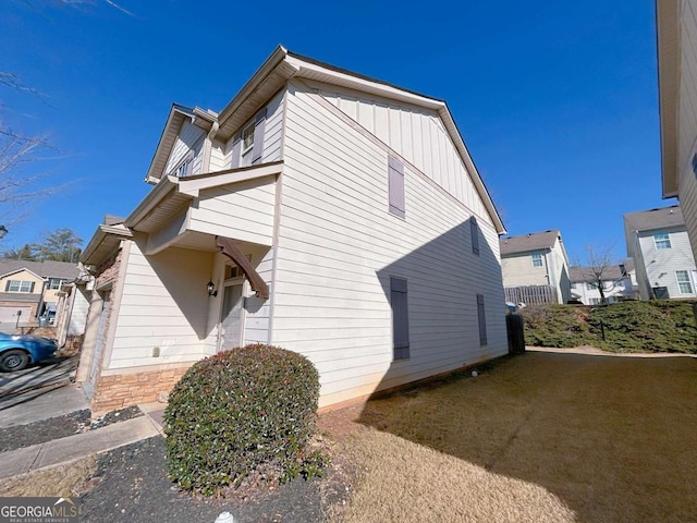 view of side of property featuring a lawn and board and batten siding