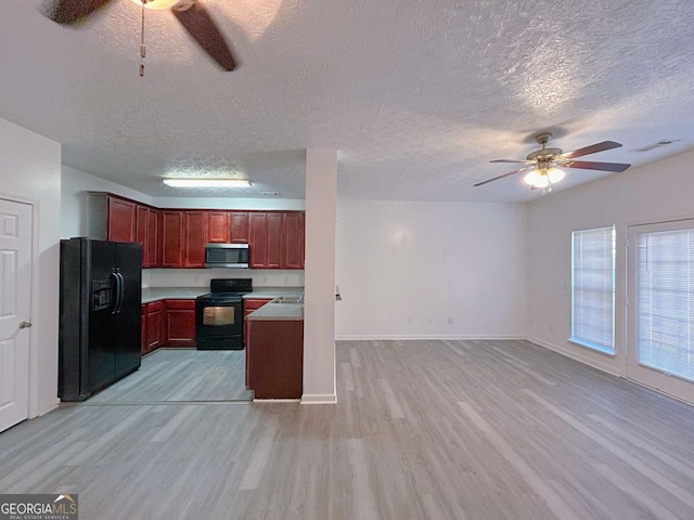 kitchen with a textured ceiling, black appliances, ceiling fan, and light wood-type flooring