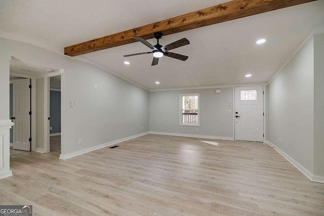 interior space featuring lofted ceiling with beams, ornamental molding, ceiling fan, and light hardwood / wood-style flooring