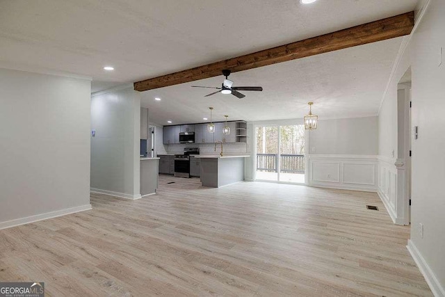unfurnished living room featuring sink, ceiling fan with notable chandelier, light hardwood / wood-style flooring, and beamed ceiling