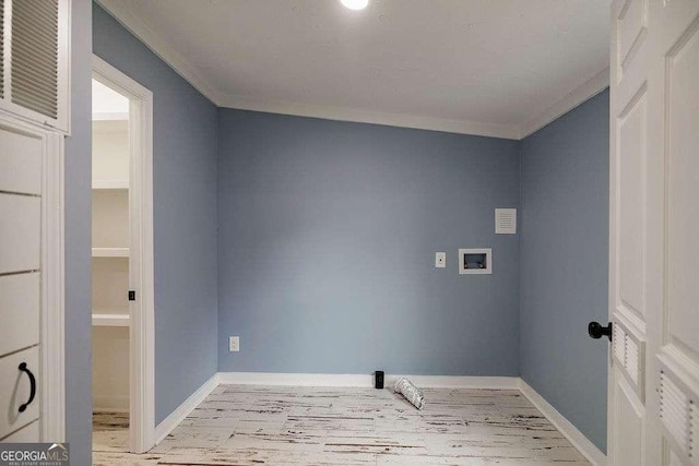 washroom featuring ornamental molding, washer hookup, and light hardwood / wood-style floors