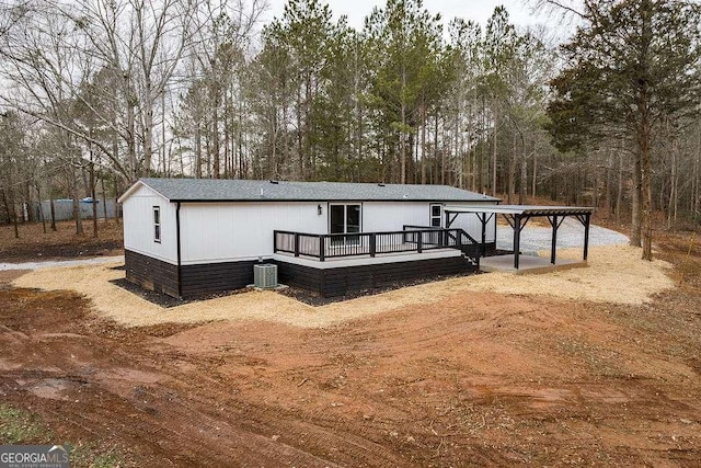 view of front of house with a wooden deck and central AC