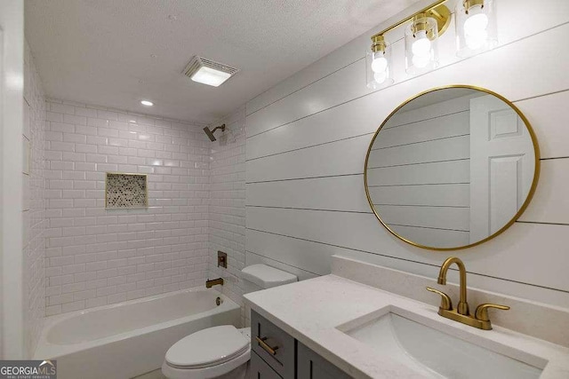 full bathroom with tiled shower / bath combo, vanity, a textured ceiling, toilet, and wood walls