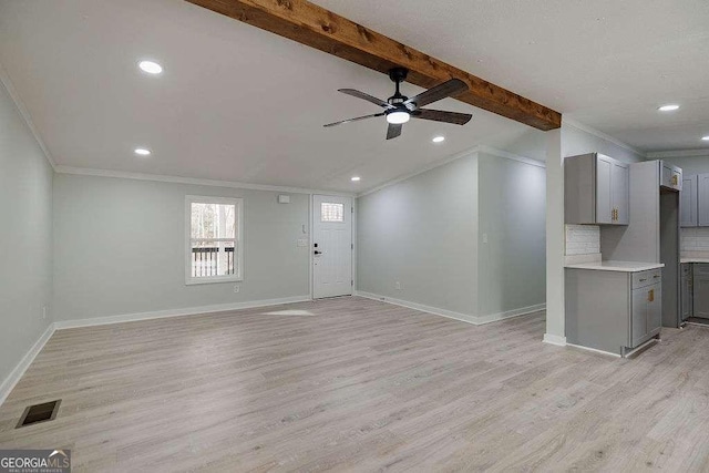 unfurnished living room with ceiling fan, crown molding, beamed ceiling, and light wood-type flooring