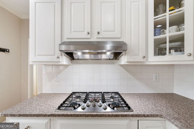 kitchen featuring tasteful backsplash, stainless steel gas stovetop, ventilation hood, and white cabinets