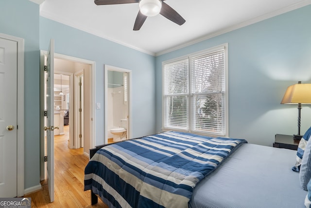 bedroom with ornamental molding, connected bathroom, ceiling fan, and light hardwood / wood-style flooring