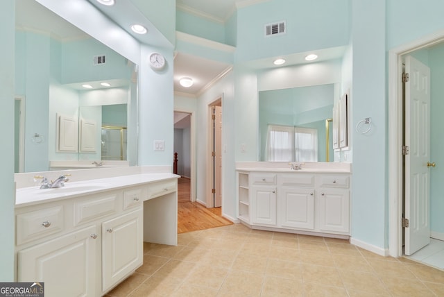 bathroom featuring vanity, crown molding, tile patterned floors, and walk in shower