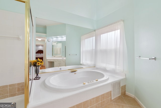 bathroom with vanity, tiled bath, and tile patterned floors