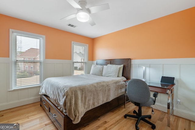 bedroom with light hardwood / wood-style floors and ceiling fan