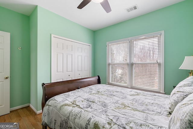 bedroom with a closet, ceiling fan, and light wood-type flooring