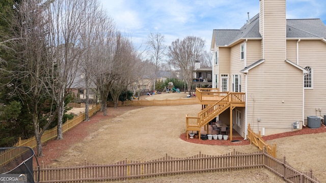 view of yard with central AC unit, a patio area, and a wooden deck