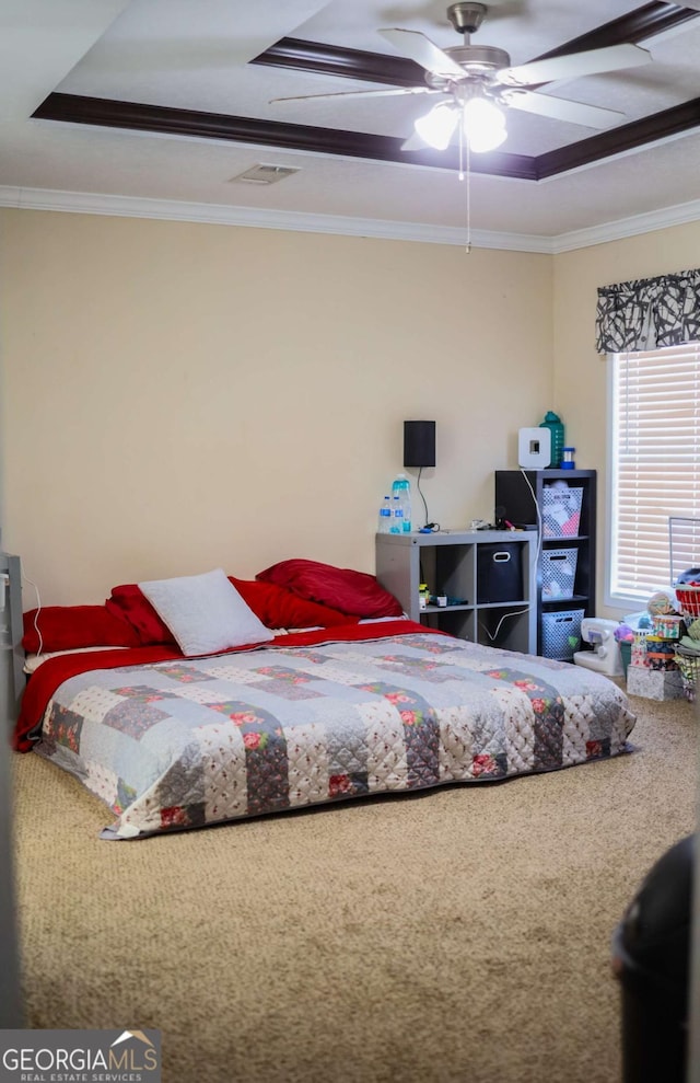 bedroom with a raised ceiling, ornamental molding, and ceiling fan