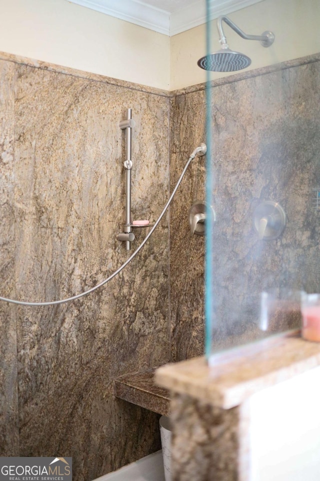 interior details with crown molding and tiled shower