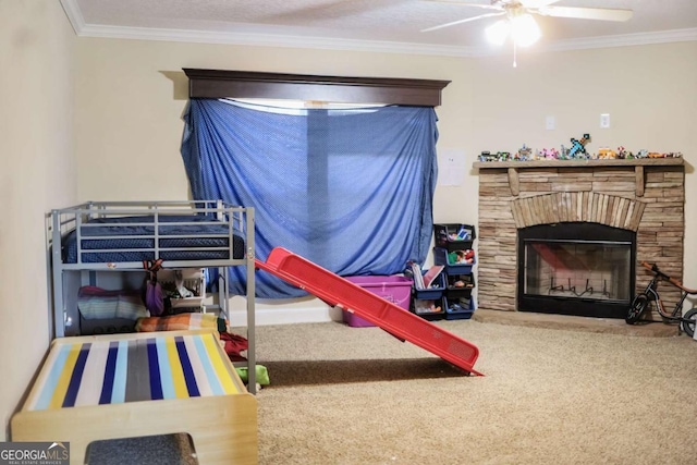 bedroom with ceiling fan, ornamental molding, a stone fireplace, and carpet