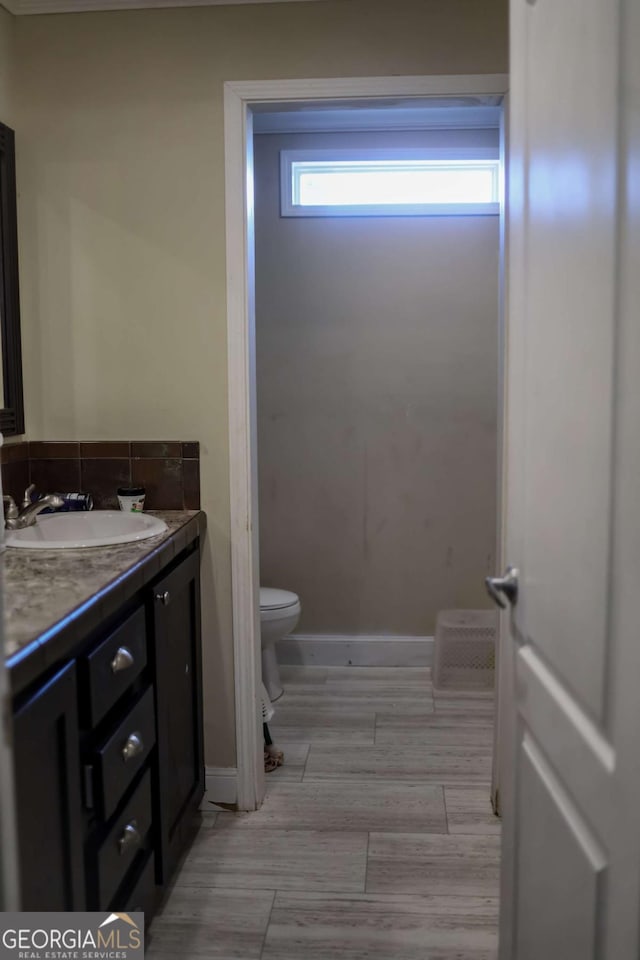 bathroom featuring vanity and toilet