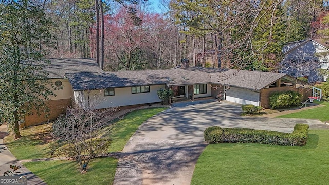 view of front of property with a front yard, driveway, and an attached garage