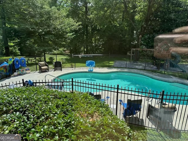 view of pool with a fenced in pool, fence, and a patio