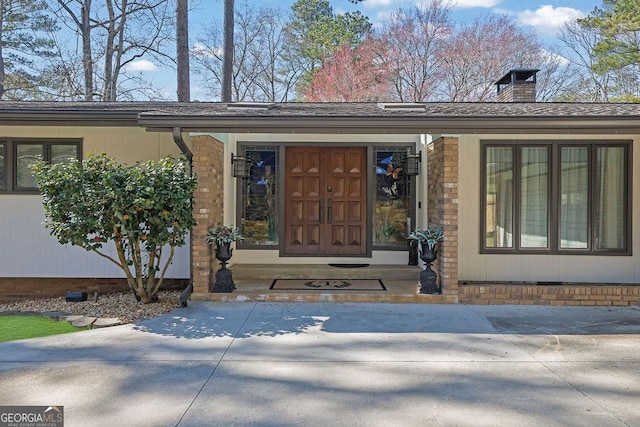 entrance to property with a chimney