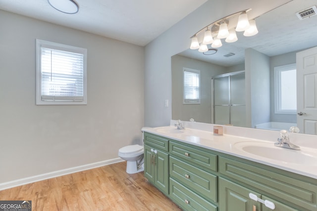 full bathroom with a healthy amount of sunlight, independent shower and bath, wood-type flooring, and vanity