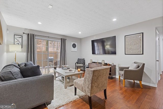 living room featuring hardwood / wood-style flooring and a textured ceiling